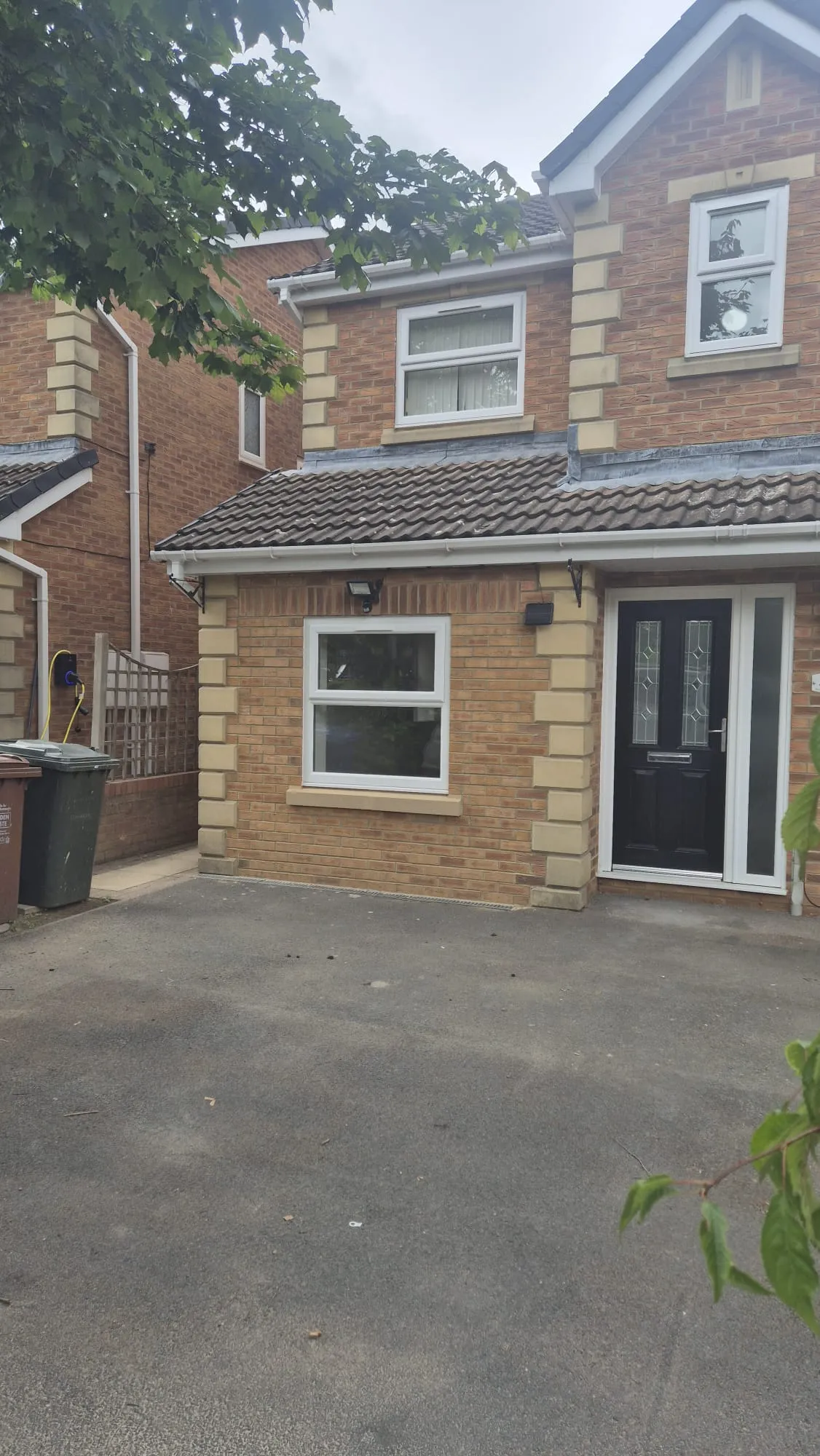 Brick house with a black door and windows